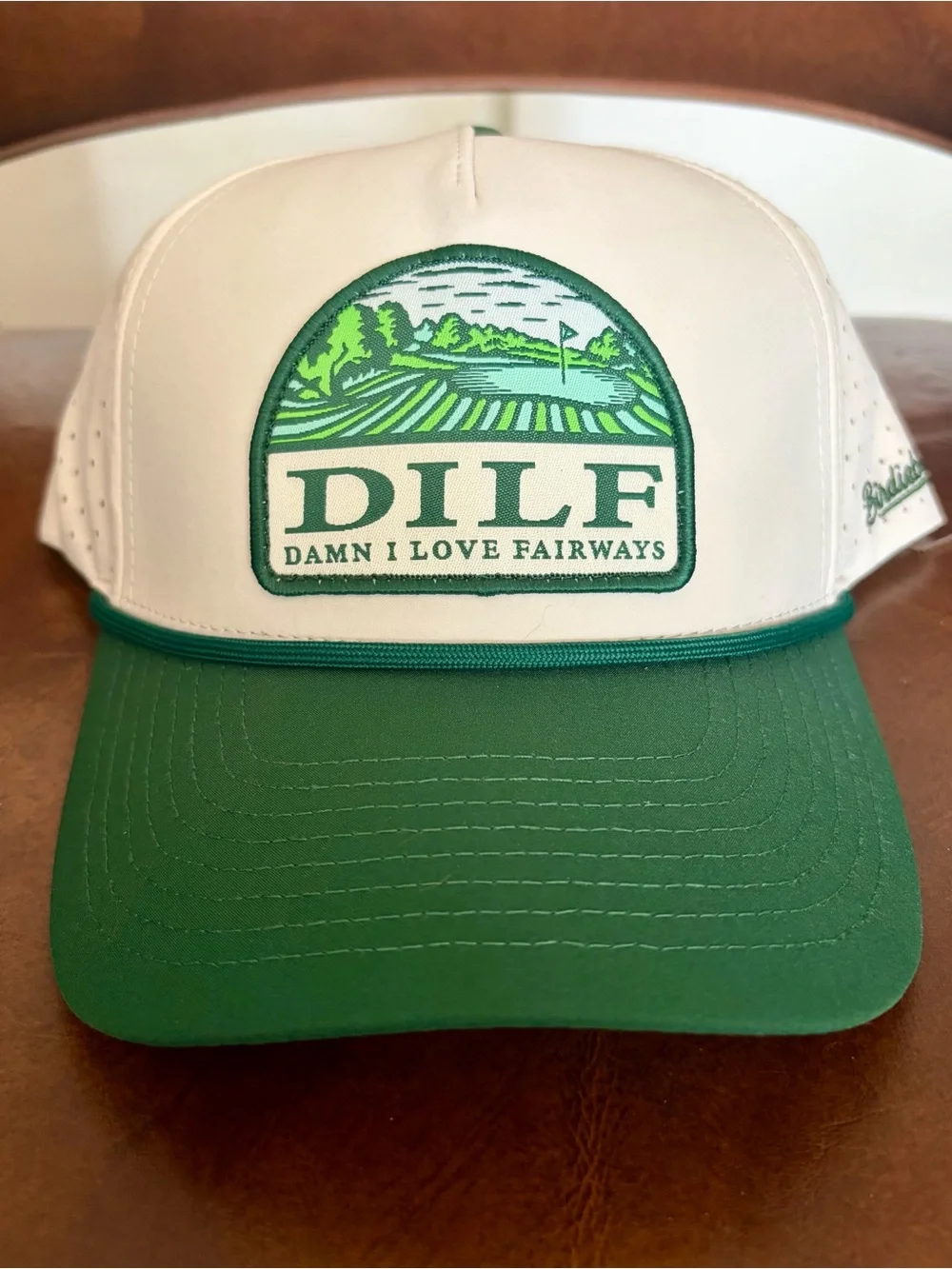 Birdieboss DILF trucker hat features a white crown, a green visor Adjustable